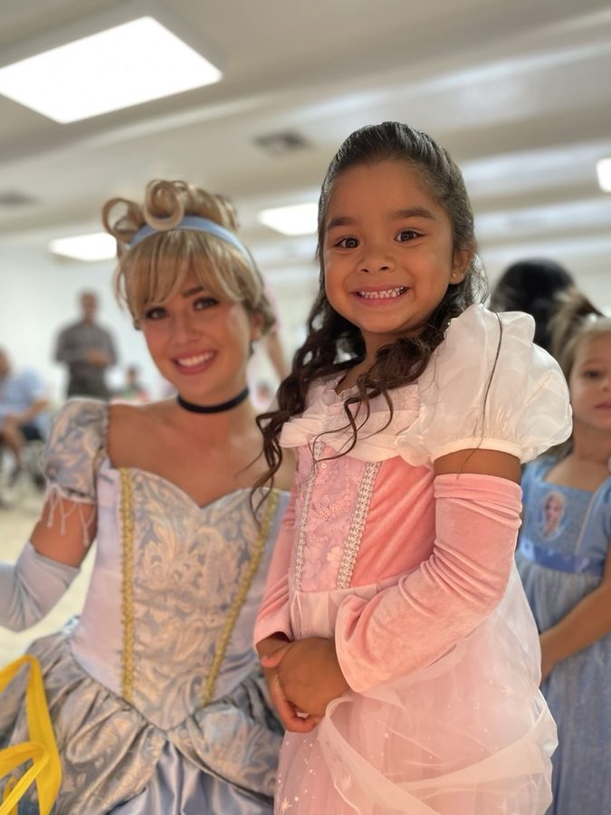 The princess sharing a joyful moment with a little birthday guest